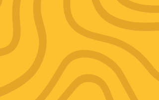 A mustard yellow background adorned with wavy, meandering lines in a slightly darker shade of yellow. The patterns flow smoothly across the image, creating an abstract, organic design reminiscent of topographic lines or natural wood grain—a perfect backdrop for a letter from the editor.