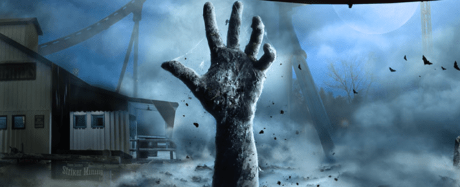 In the eerie landscape of Waterloo, a large, zombie-like hand emerges from the ground amidst dark, foggy surroundings. A misty roller coaster track twists under an eerie full moon, heightening the Halloween thrills as crows fly nearby in celebration of spooky festivities.