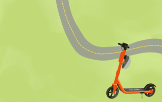 An orange e-scooter is parked on a green field next to a winding gray road, marking the rise of sustainable travel options in the Waterloo region. The scooter is angled to the right and features the logo "neuron" on its base.