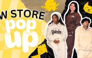 Three people don hoodies and sweatpants branded with "University of Waterloo" and "CORPTEAM," set against a vibrant yellow and black backdrop. The scene features "W STORE pop up" in bold, accompanied by playful paper crane and cat illustrations, highlighting the exclusive limited-edition tee.