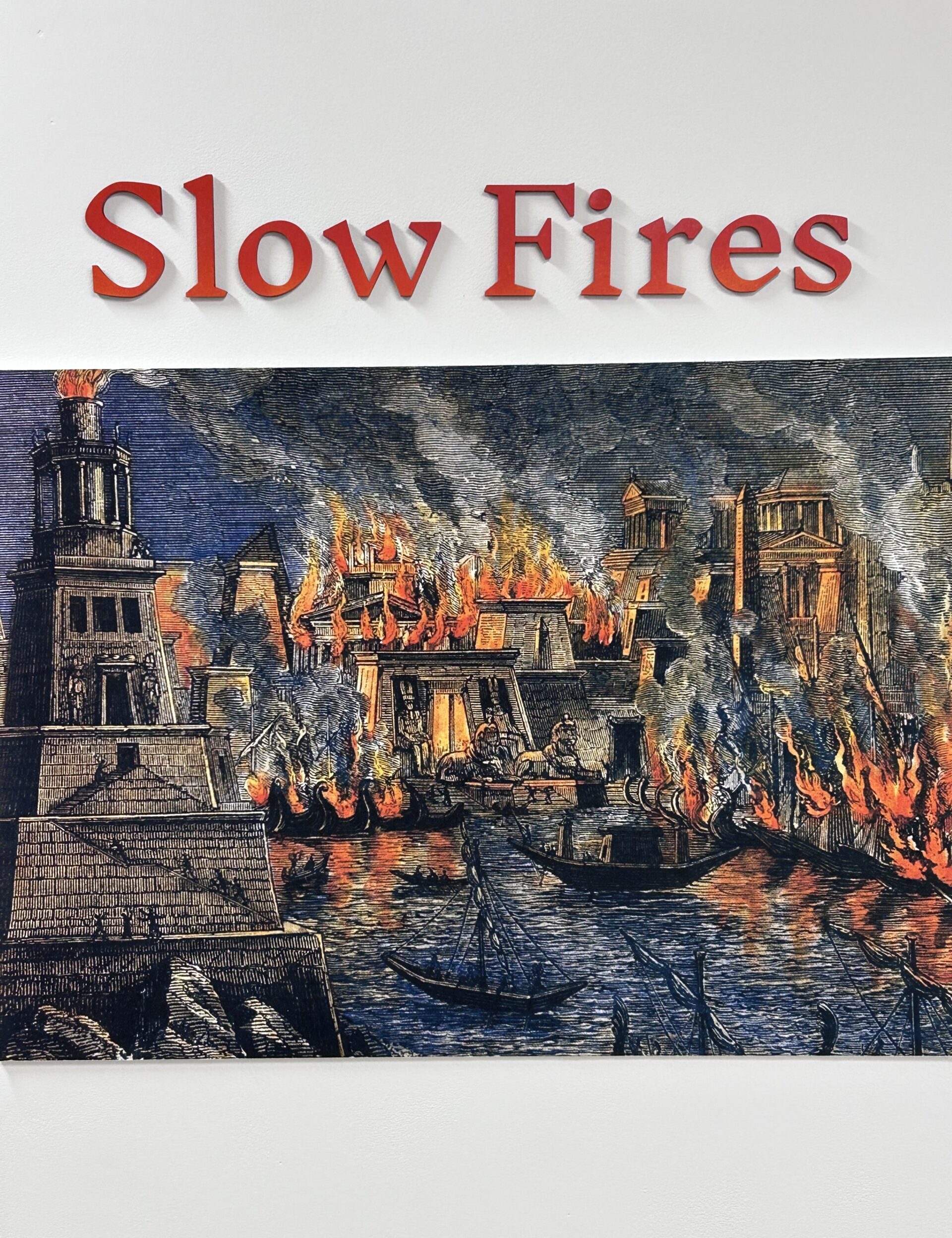 Illustration of a historical cityscape with tall buildings engulfed in flames and smoke, reminiscent of dying archives. Boats are visible on a river in the foreground. The text "Slow Fires" is displayed in red at the top.