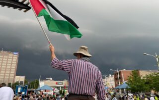 A protestor holding up a Palestinian flag in Waterloo Town Square on July 24. (Photo credit: Brendon Poste)