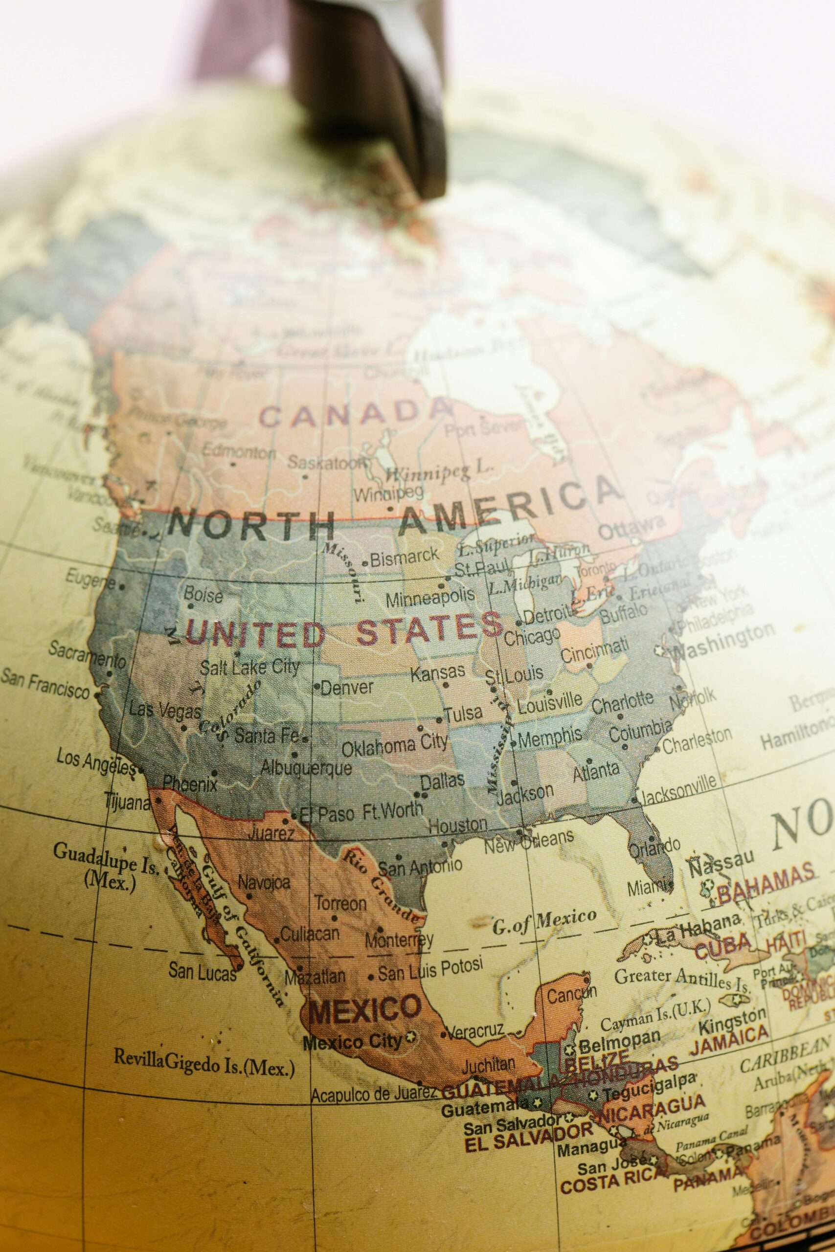 A close-up of a globe showing North America, including Canada, the United States, Mexico, and parts of Central America and the Caribbean. Country and city names are clearly visible, offering insight into the US Canada political climate.